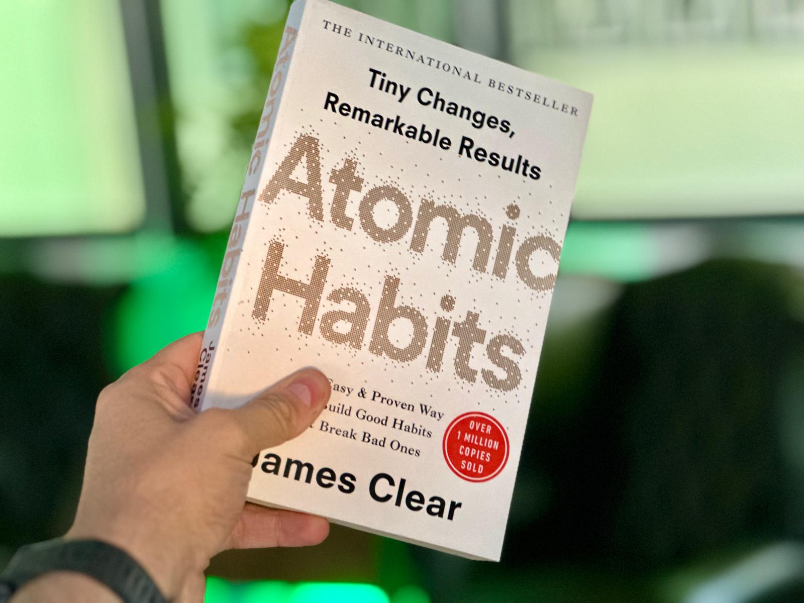 Book cover of Atomic Habits by James Clear with illustration of small changes leading to big outcomes
